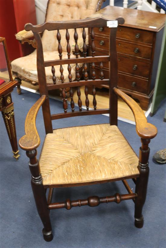 An early 19th century oak spindle back chair